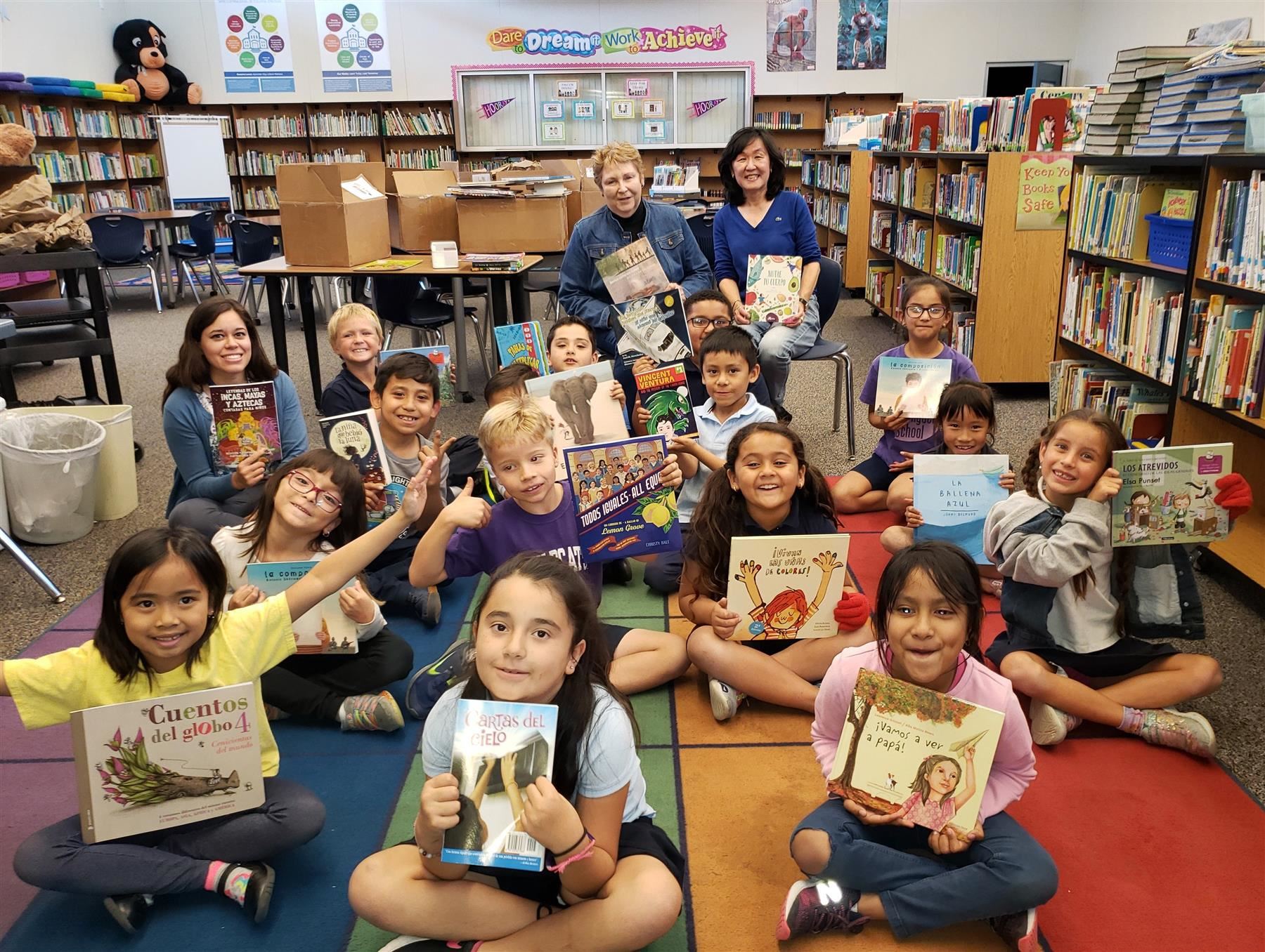 students receive books donated from volunteers